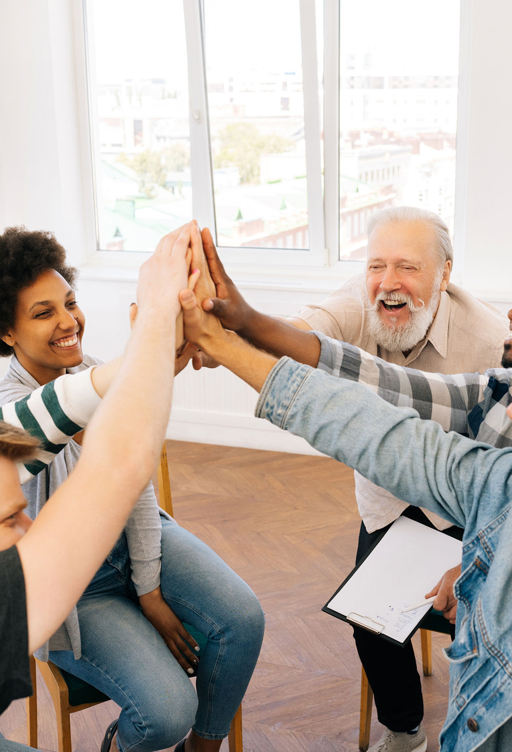High-angle view of happy overjoyed multicultural and different ages people celebrating success, work achieve, giving high five, shouting, smiling, laughing.